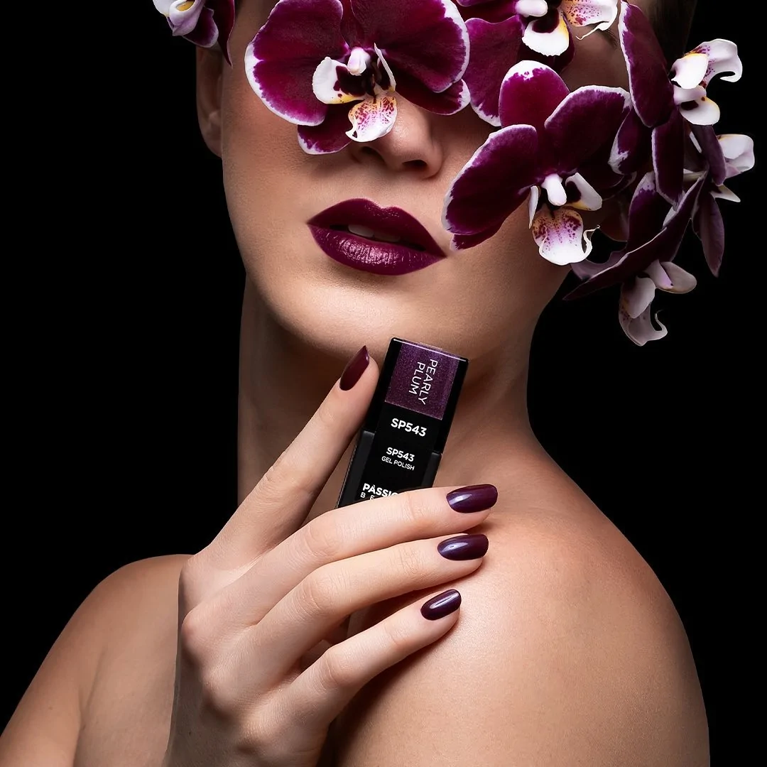 Passione Beauty deep plum purple glossy gel polish on oval nails, elegant manicure with pearly effect for nail artists