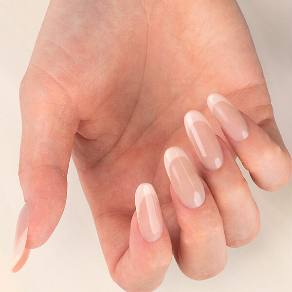 Passione Beauty beige nude glossy gel polish on long almond nails, natural elegant manicure for nail artists