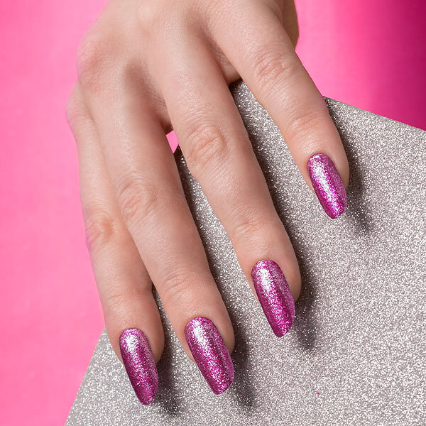 Passione Beauty fuchsia pink glitter gel polish on almond-shaped nails, sparkling nail art effect professional manicure